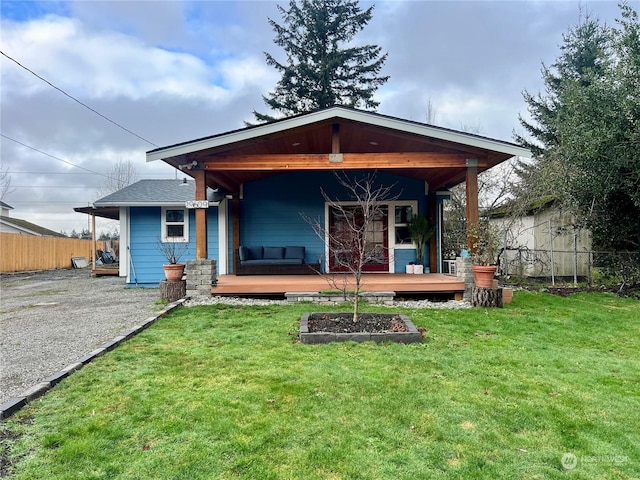 back of house with a wooden deck and a lawn