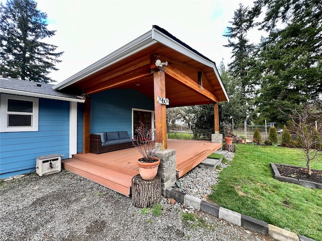 wooden deck featuring a lawn