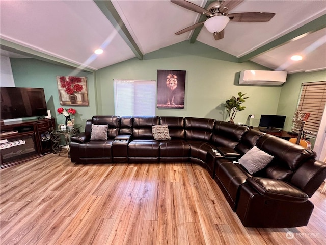 living room with ceiling fan, a wall mounted air conditioner, light hardwood / wood-style floors, and lofted ceiling with beams