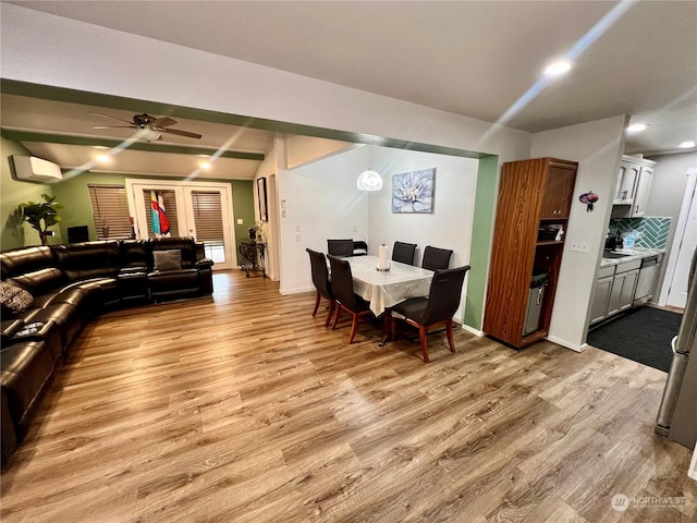 dining area featuring light hardwood / wood-style floors, ceiling fan, and a wall mounted AC