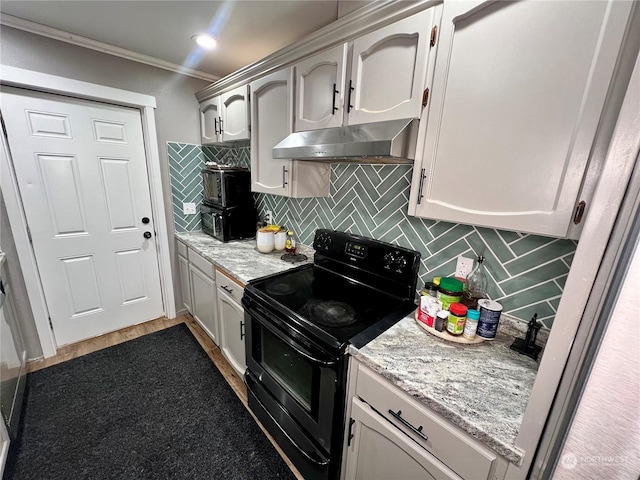 kitchen with hardwood / wood-style flooring, light stone countertops, decorative backsplash, electric range, and ornamental molding