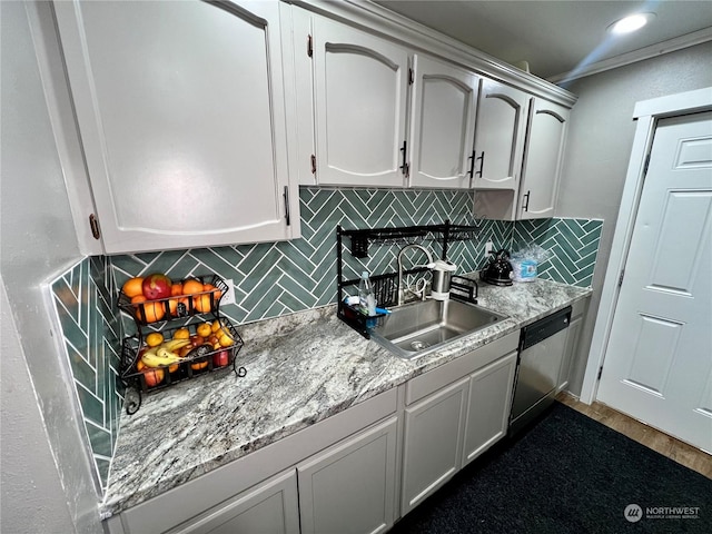 kitchen featuring dishwasher, tasteful backsplash, white cabinets, ornamental molding, and sink