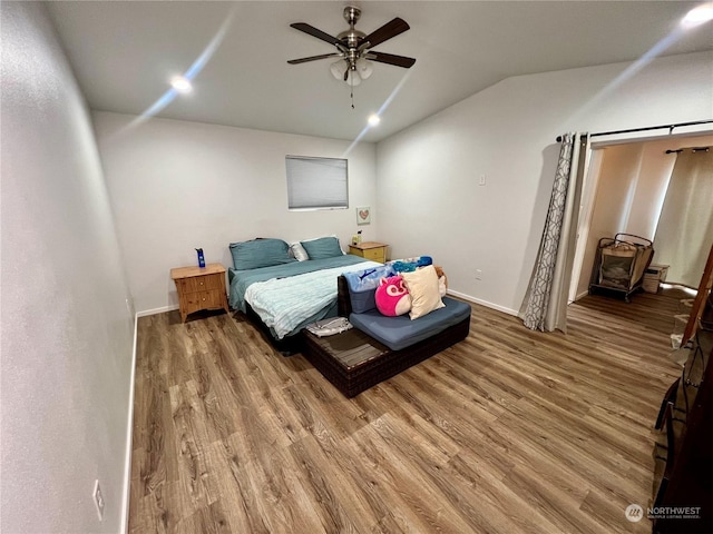 bedroom with lofted ceiling, ceiling fan, and wood-type flooring