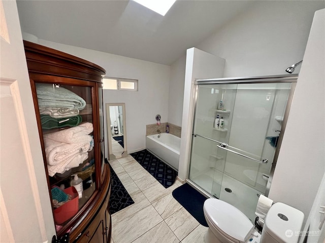 bathroom featuring toilet and shower with separate bathtub