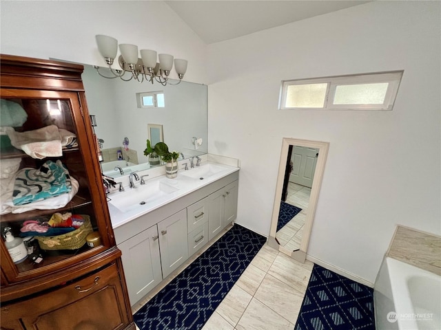 bathroom with lofted ceiling, vanity, tile patterned flooring, and a bathing tub