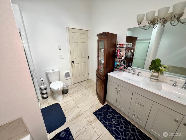 bathroom featuring toilet, vanity, and tile patterned flooring