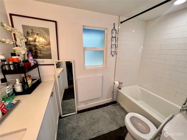 full bathroom with toilet, tiled shower / bath, tile patterned floors, and vanity