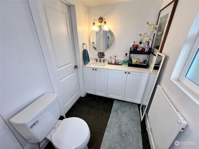 bathroom featuring vanity, tile patterned flooring, and toilet