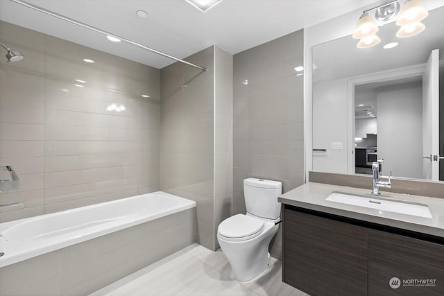 full bathroom with tile patterned floors, toilet, vanity, and tiled shower / bath