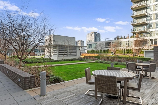 wooden terrace with a lawn