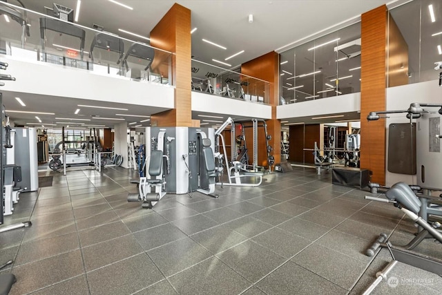 workout area featuring a towering ceiling