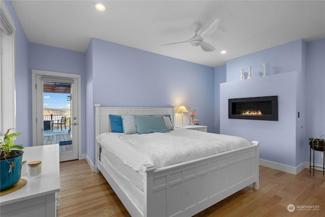 bedroom with access to exterior, ceiling fan, and light hardwood / wood-style flooring