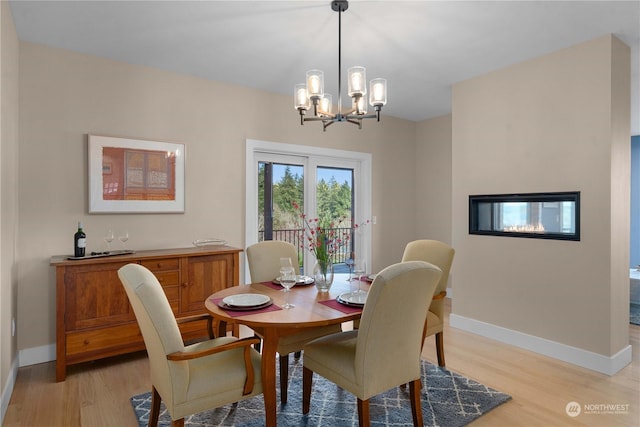 dining room featuring a chandelier and light wood-type flooring