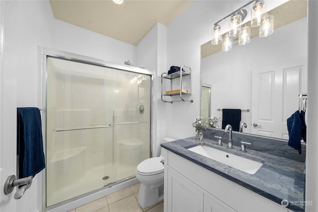 bathroom with vanity, toilet, walk in shower, and tile patterned flooring