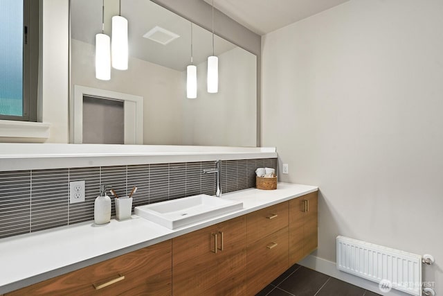 bathroom featuring tile patterned flooring, vanity, visible vents, decorative backsplash, and radiator heating unit