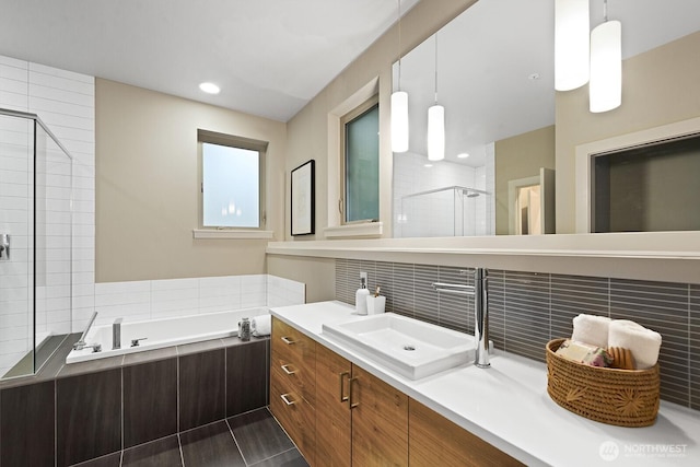 bathroom with a garden tub, recessed lighting, backsplash, a stall shower, and vanity