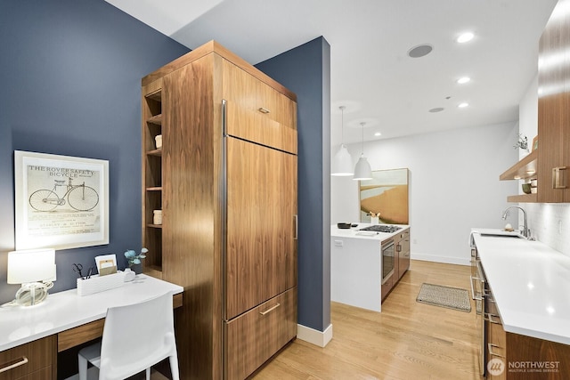 kitchen featuring open shelves, brown cabinets, and light countertops