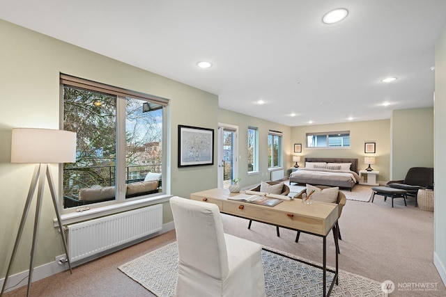 interior space with baseboards, radiator heating unit, recessed lighting, and light colored carpet