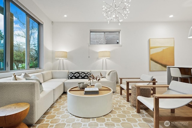 living room with recessed lighting and an inviting chandelier