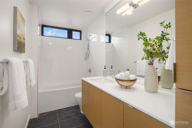 full bathroom featuring toilet, vanity, tile patterned floors, and tiled shower / bath combo