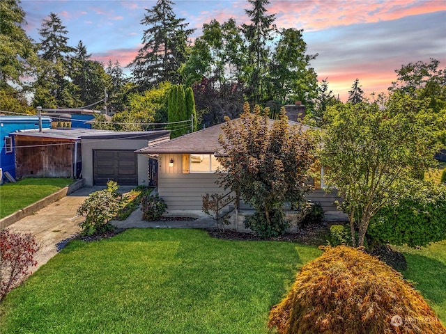 view of front of house with a yard and a garage