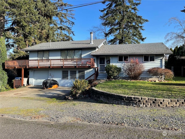 view of front of home with a garage, a deck, and a front lawn