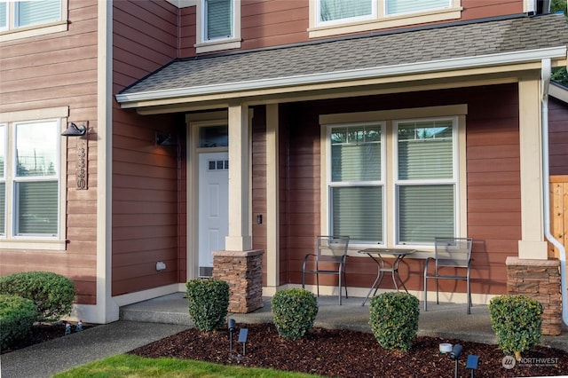 view of exterior entry with covered porch