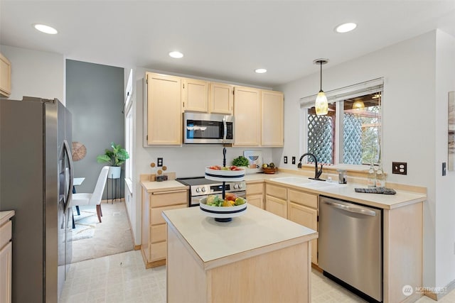 kitchen with appliances with stainless steel finishes, a center island, pendant lighting, light brown cabinets, and sink