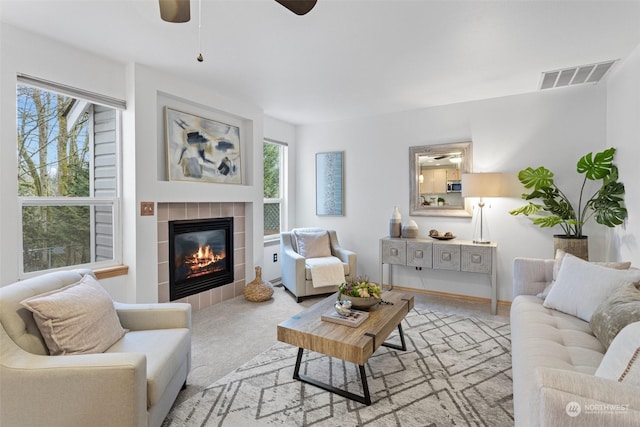 carpeted living room with a fireplace and a wealth of natural light