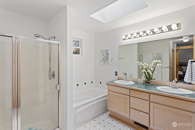 bathroom featuring vanity, a skylight, and plus walk in shower