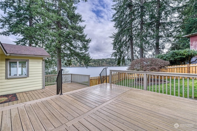 wooden deck featuring a lawn