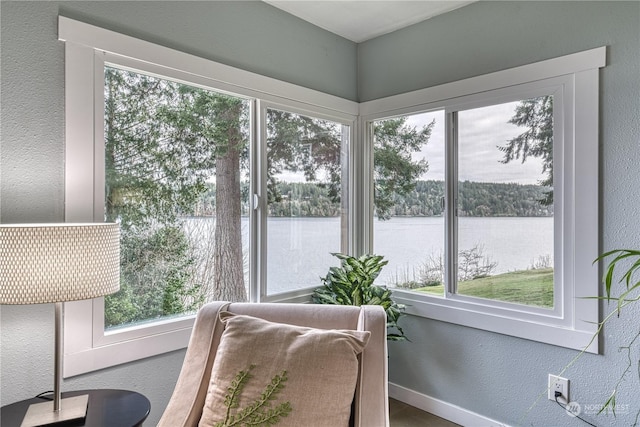 sunroom / solarium with a water view