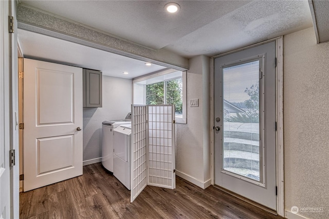 washroom featuring dark hardwood / wood-style flooring, a textured ceiling, and independent washer and dryer