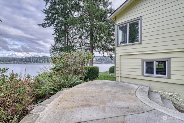 view of patio with a water view