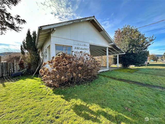 view of property exterior with a lawn