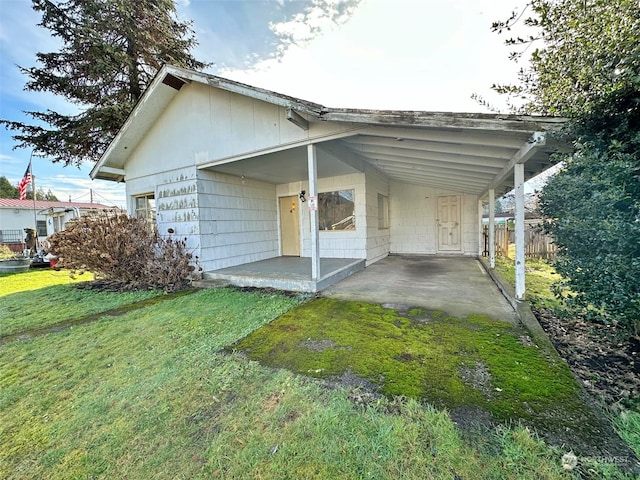 view of property exterior featuring a carport and a lawn