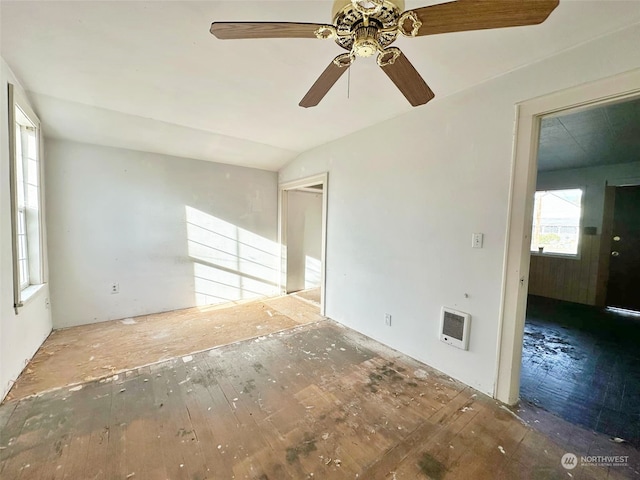 unfurnished room with heating unit, ceiling fan, and lofted ceiling