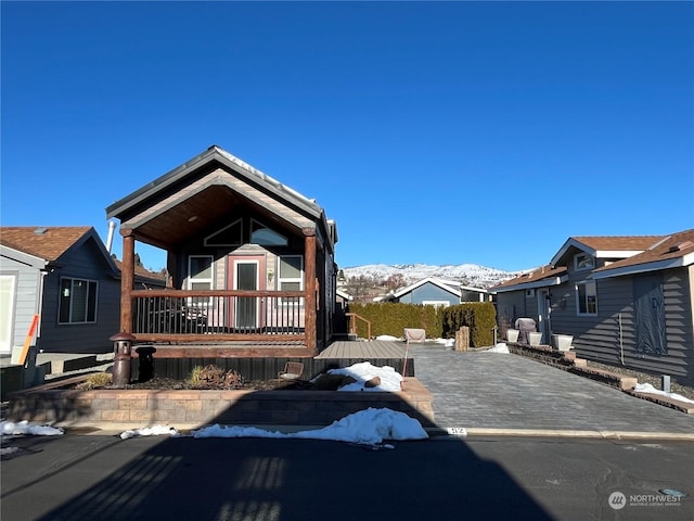 view of front of home featuring a deck with mountain view