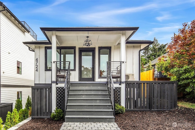 view of exterior entry featuring a porch