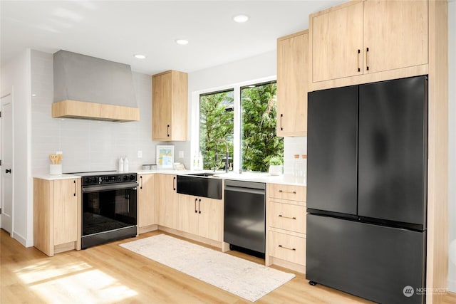 kitchen featuring light brown cabinets, dishwasher, black range with electric cooktop, fridge, and custom exhaust hood