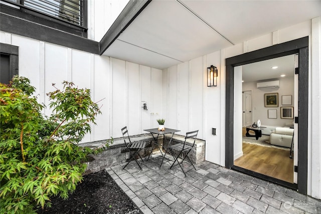 view of patio with an AC wall unit