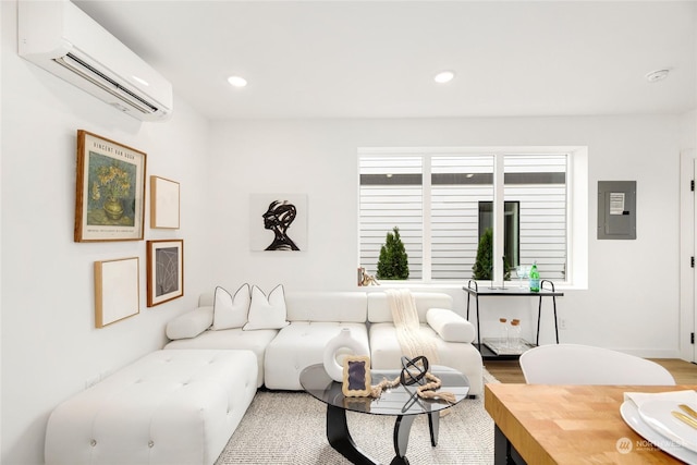 living room with electric panel, wood-type flooring, and a wall mounted air conditioner