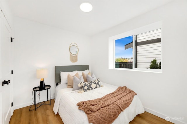 bedroom with wood-type flooring