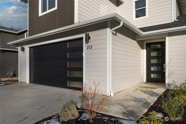 doorway to property with a garage