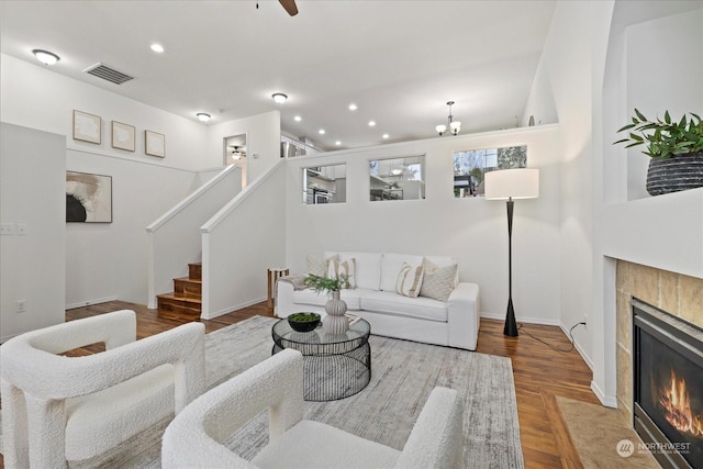 living room featuring a tile fireplace and wood-type flooring