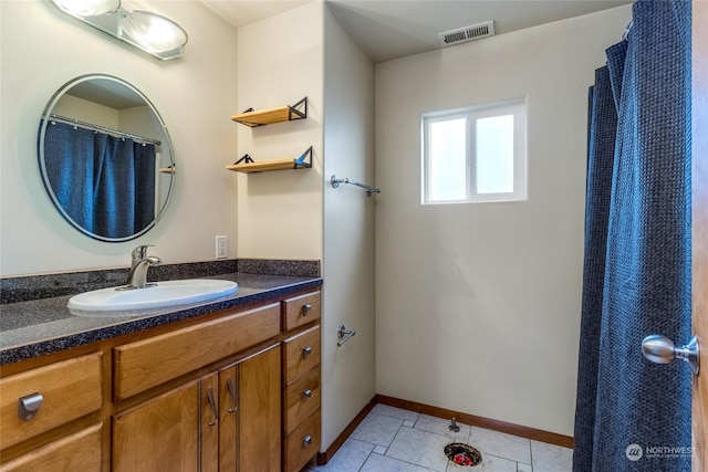 bathroom with vanity and tile patterned flooring