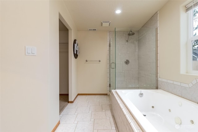 bathroom featuring tile patterned flooring and independent shower and bath