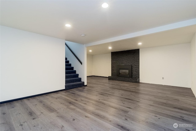 basement featuring a fireplace and hardwood / wood-style flooring