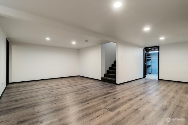 basement with light hardwood / wood-style flooring