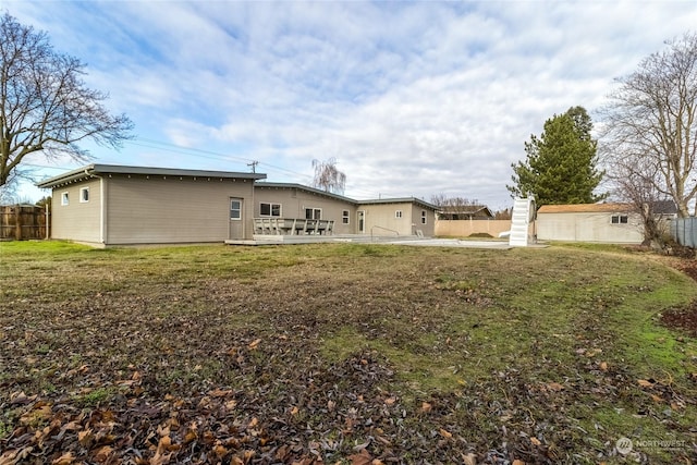 back of house featuring a patio area and a yard